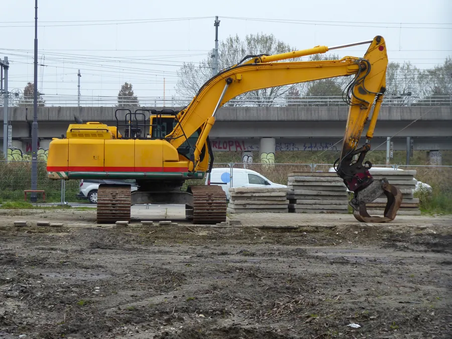 Large yellow excavator at an active earthworks site